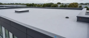 Clean UK flat roof with rooflight, trims and outlet ready for inspection