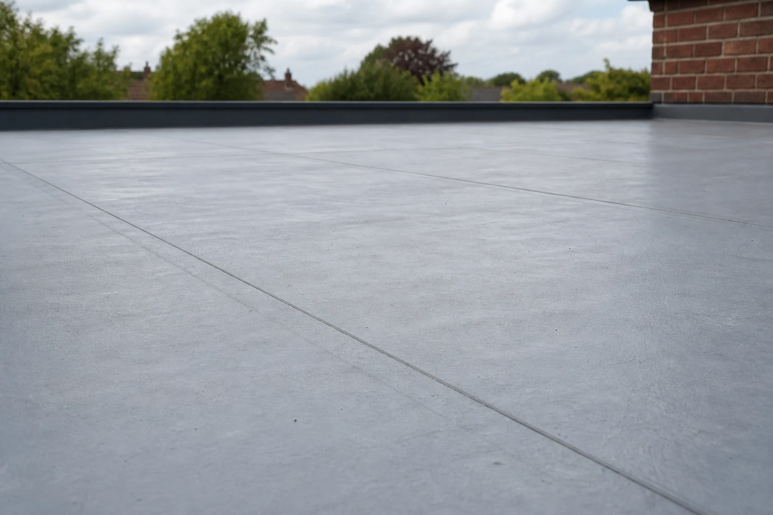 Flat roof membrane surface showing seams and light ageing